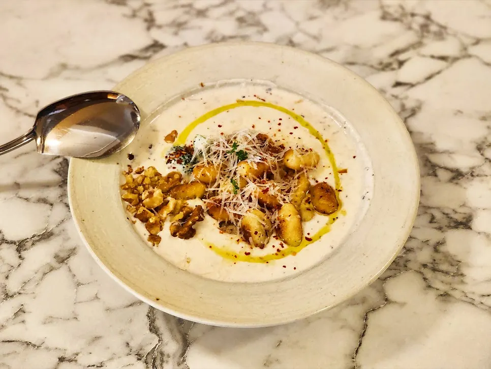 Truffle cream gnocchi topped with nuts