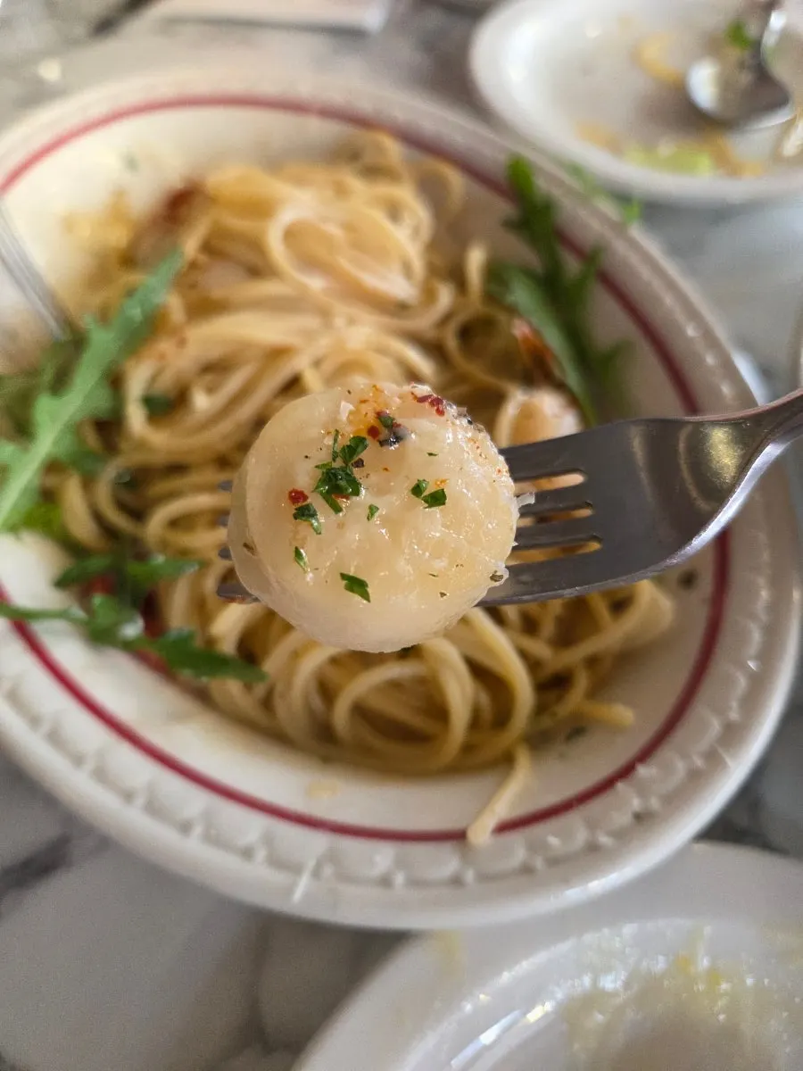Scooping up the truffle cream sauce with gnocchi