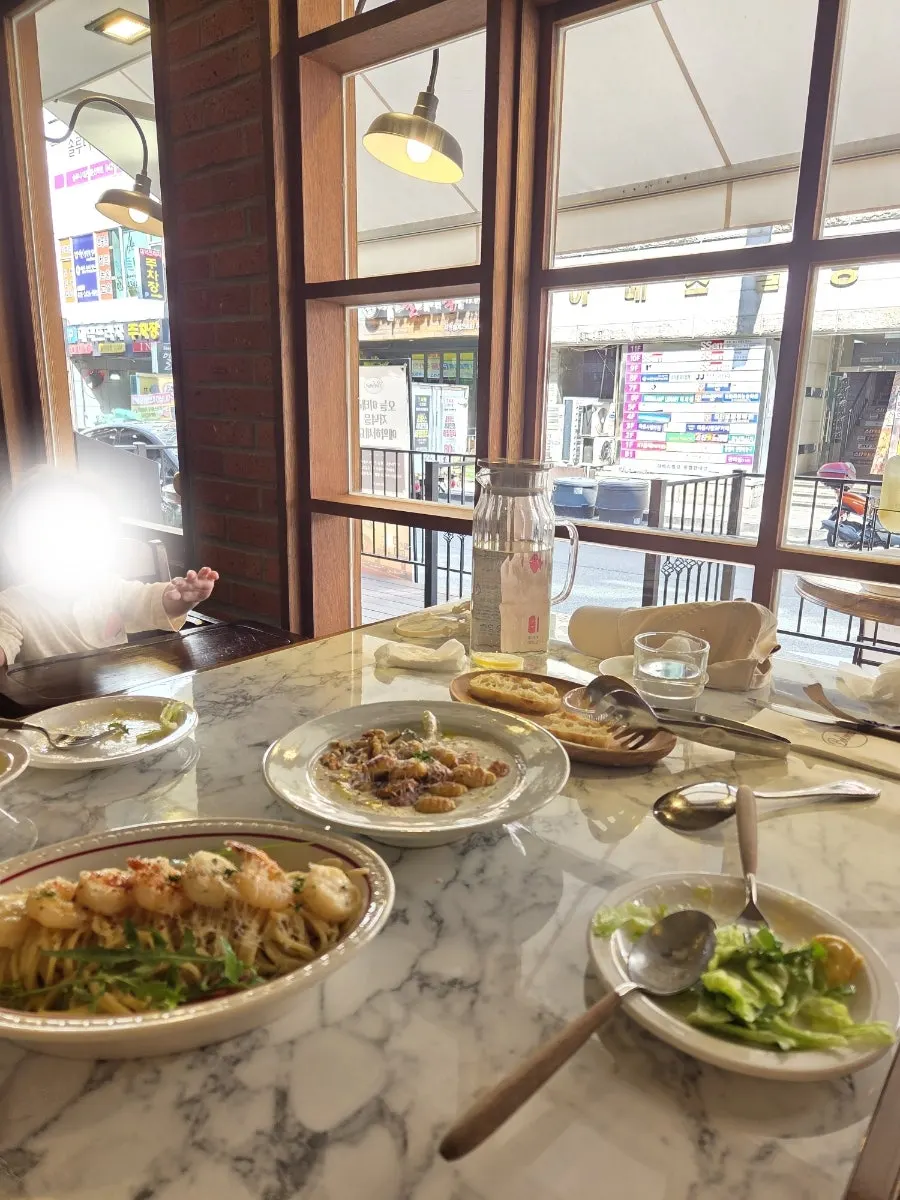 A full Italian meal set at the window seat