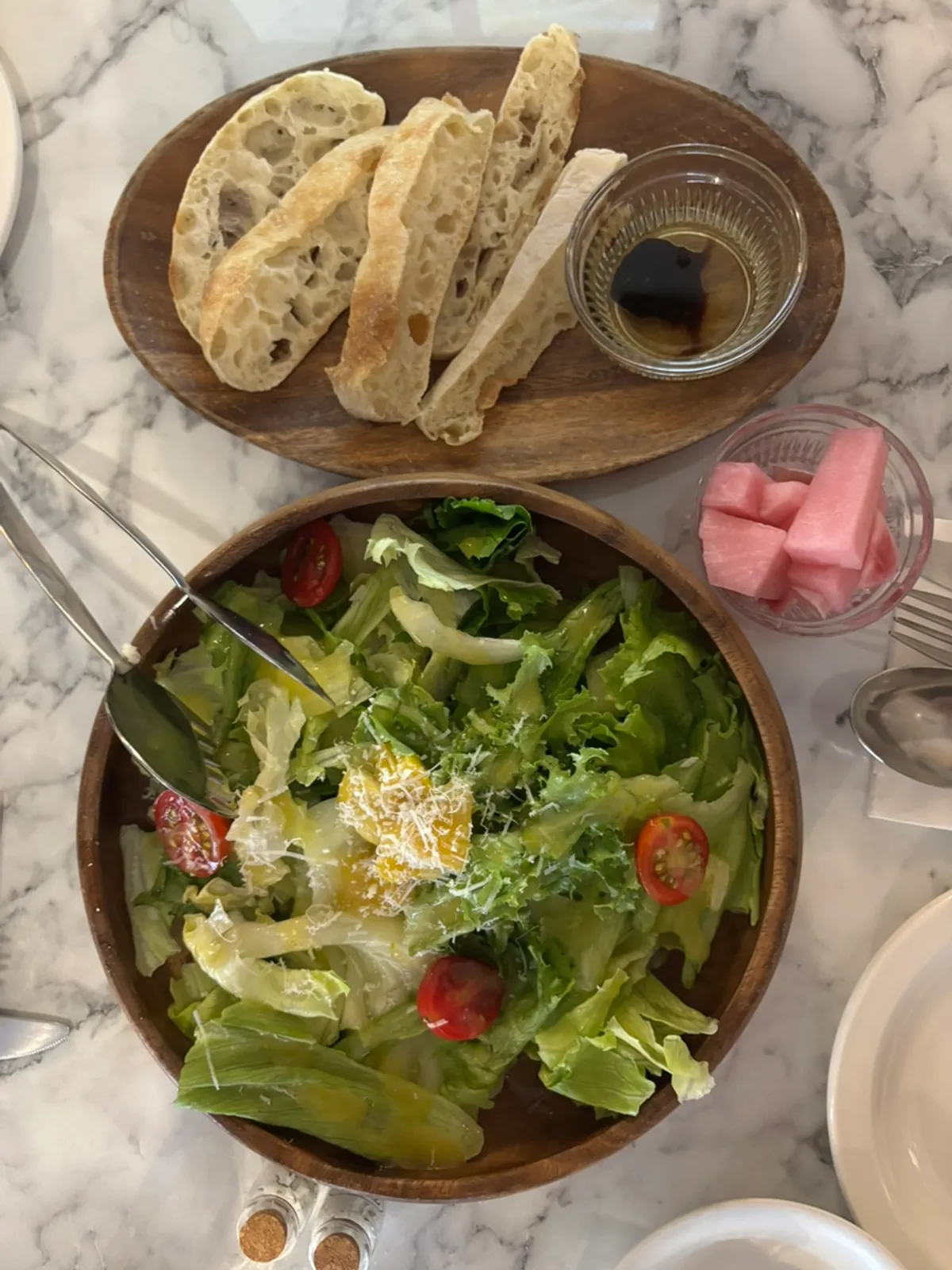 Table set with pre-meal bread, salad, and cream soup