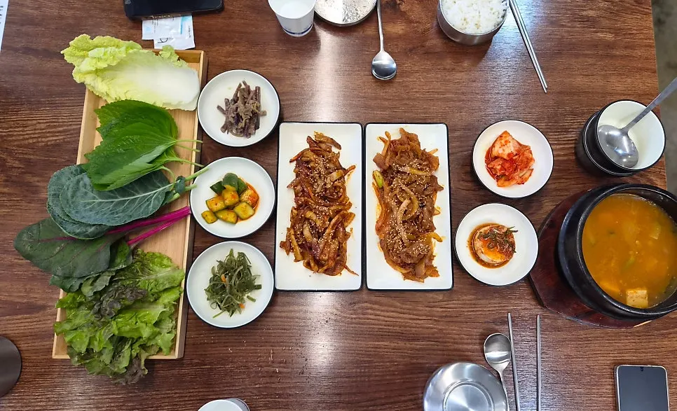 Full spread with pork stir-fry and squid stir-fry served together