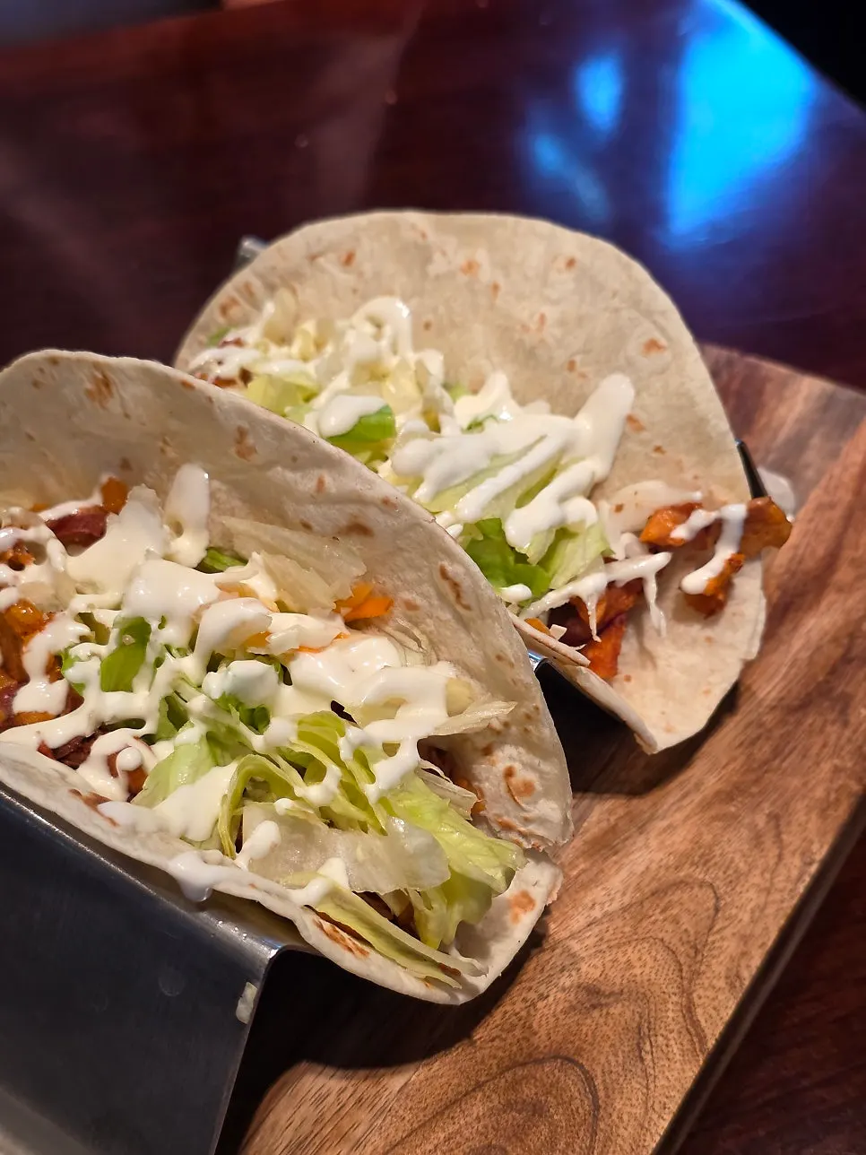 Chicken taco topped with seasoned chicken and salad