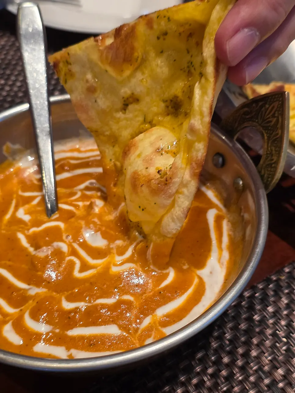 Dipping naan into the curry
