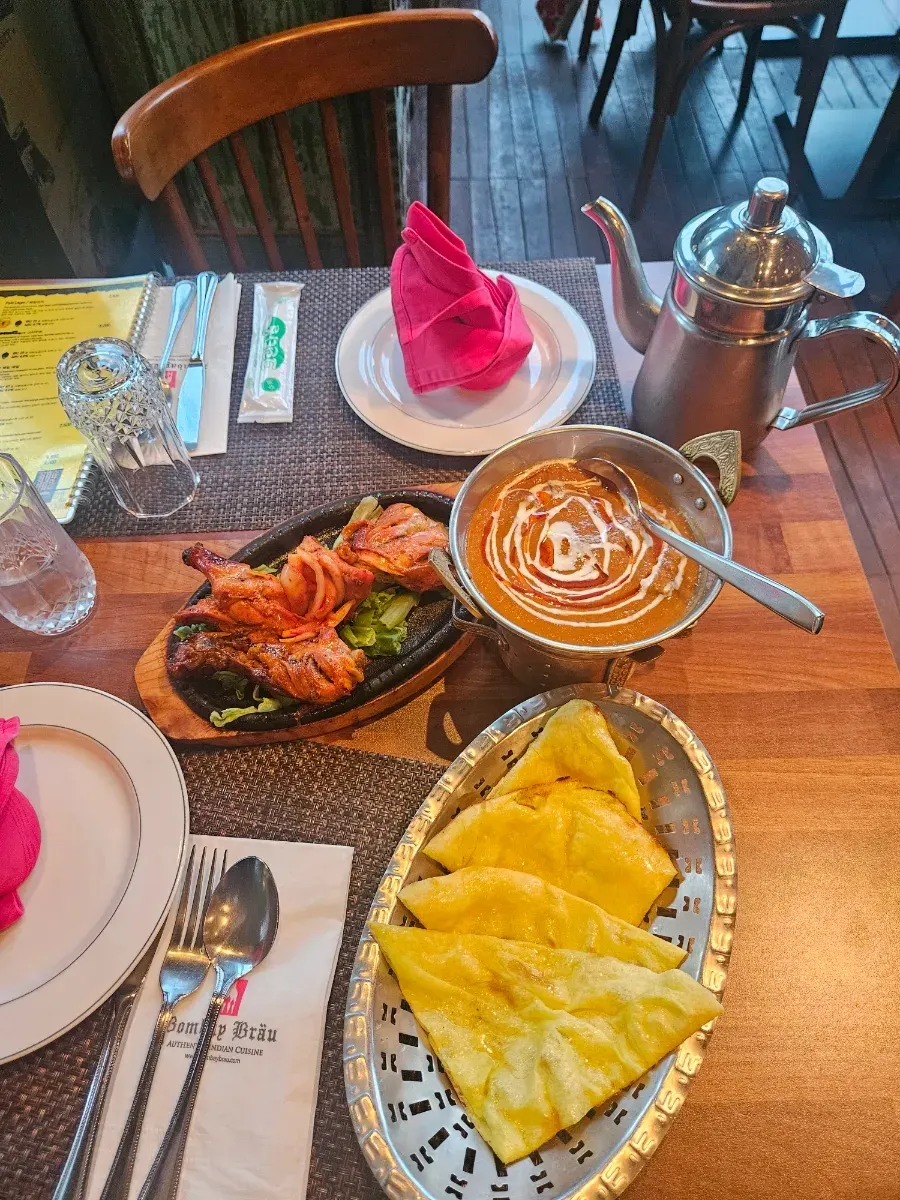 Lamb korma curry and naan set on the table