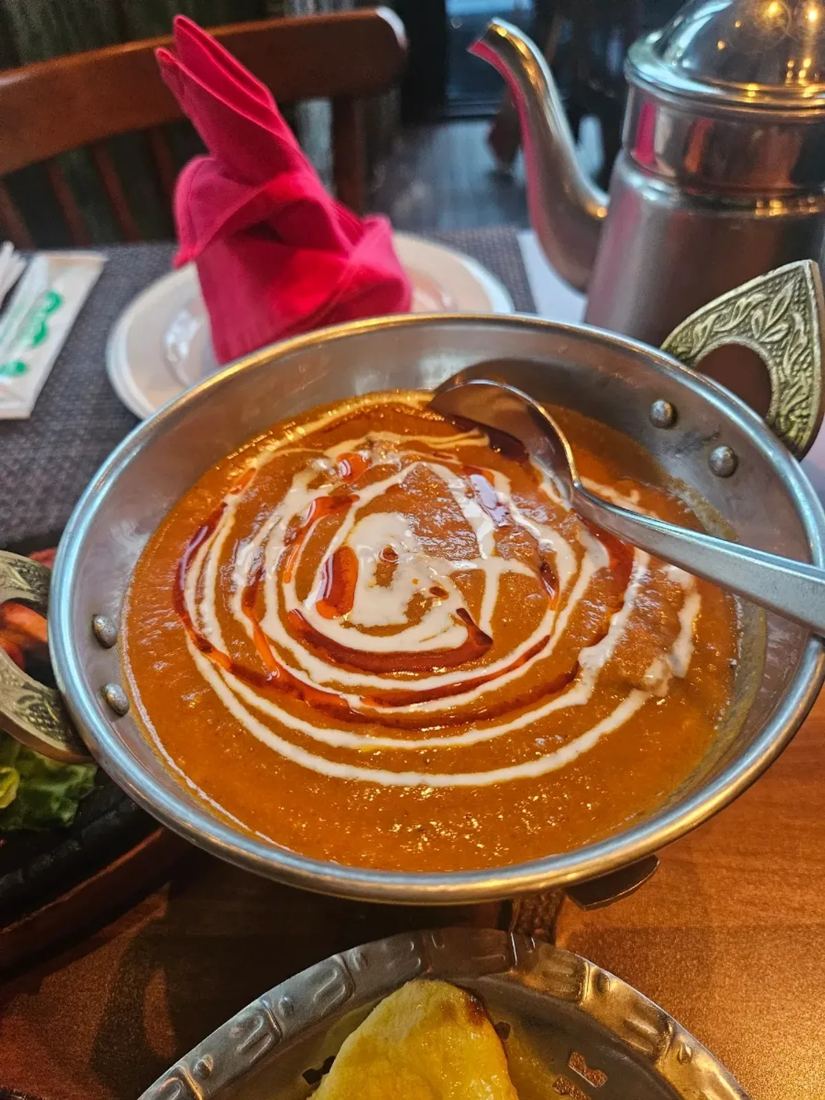 Glossy garlic naan served alongside the curry