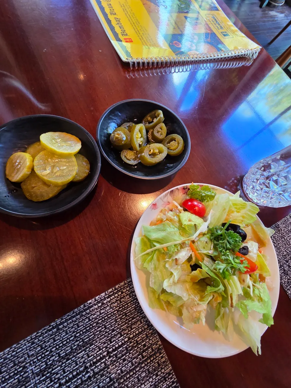 Salad and pickles served after ordering
