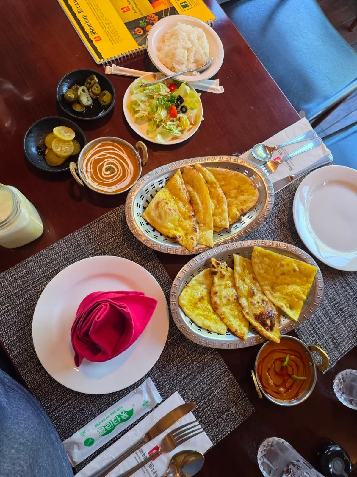 A separately ordered glass of mango lassi