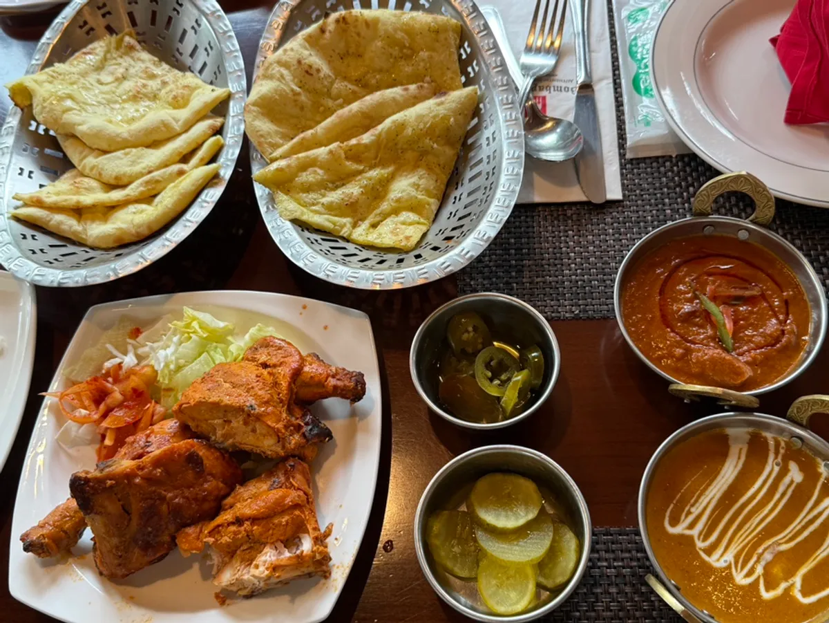 B set spread with two curries, naan and tandoori chicken