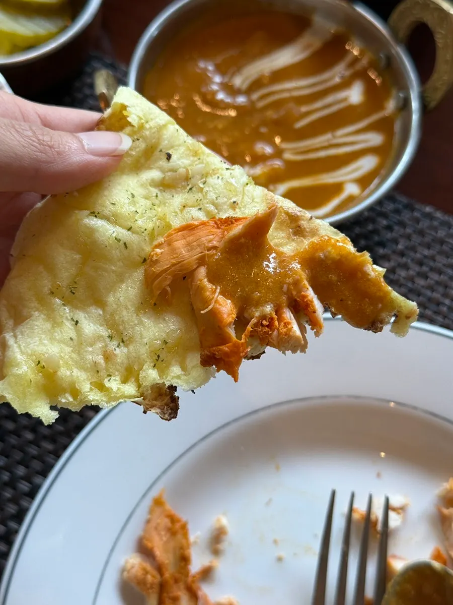 Dipping naan into the curry