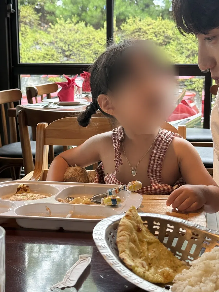 Family sharing garlic naan at the table