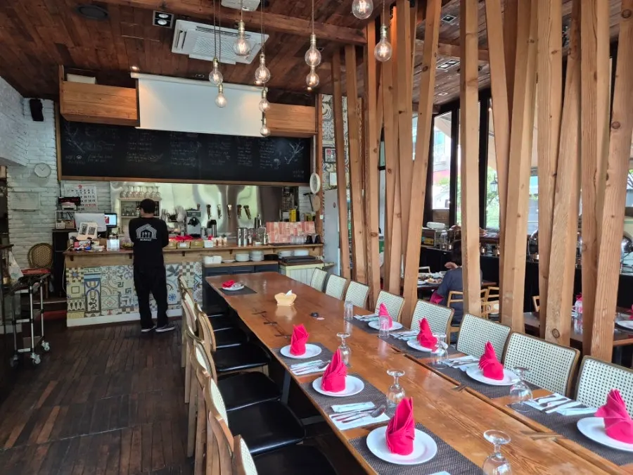 Open kitchen lined with beer taps and mosaic-tiled interior