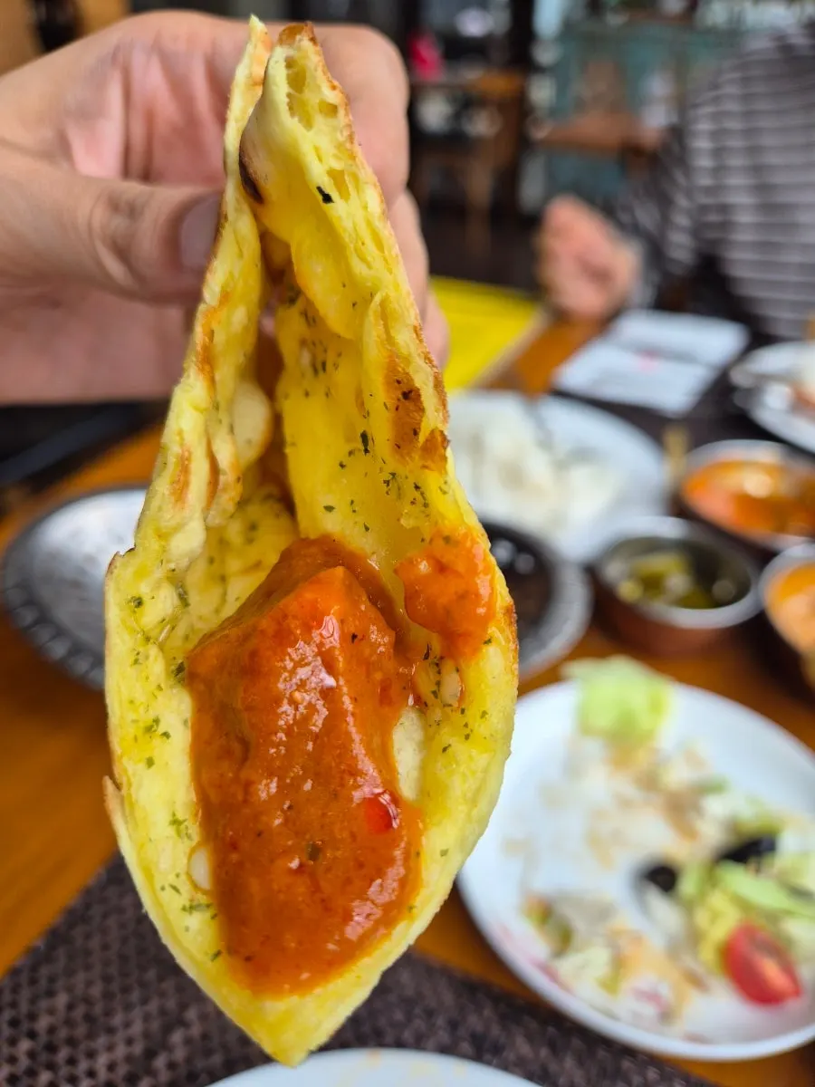 A spoonful of chicken tikka masala curry lifted up