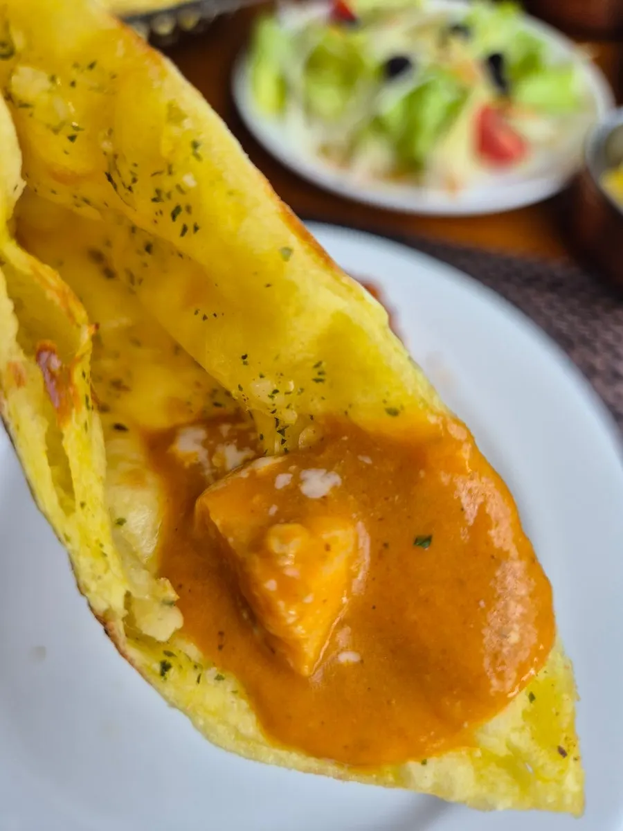A bowl of smooth butter chicken curry