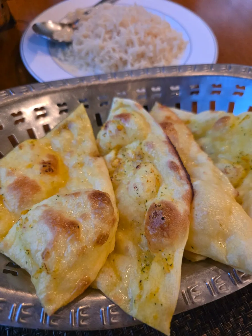 Dipping butter naan into the tikka masala curry