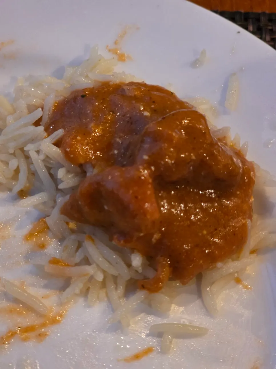 Finishing the meal with tikka masala over rice