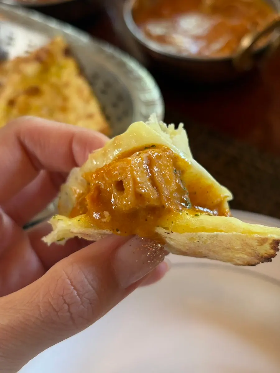 Dipping naan into curry