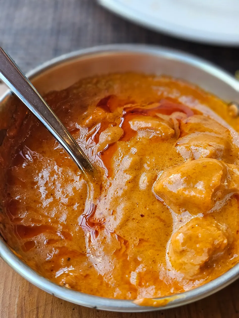 Dipping naan into chicken tikka masala
