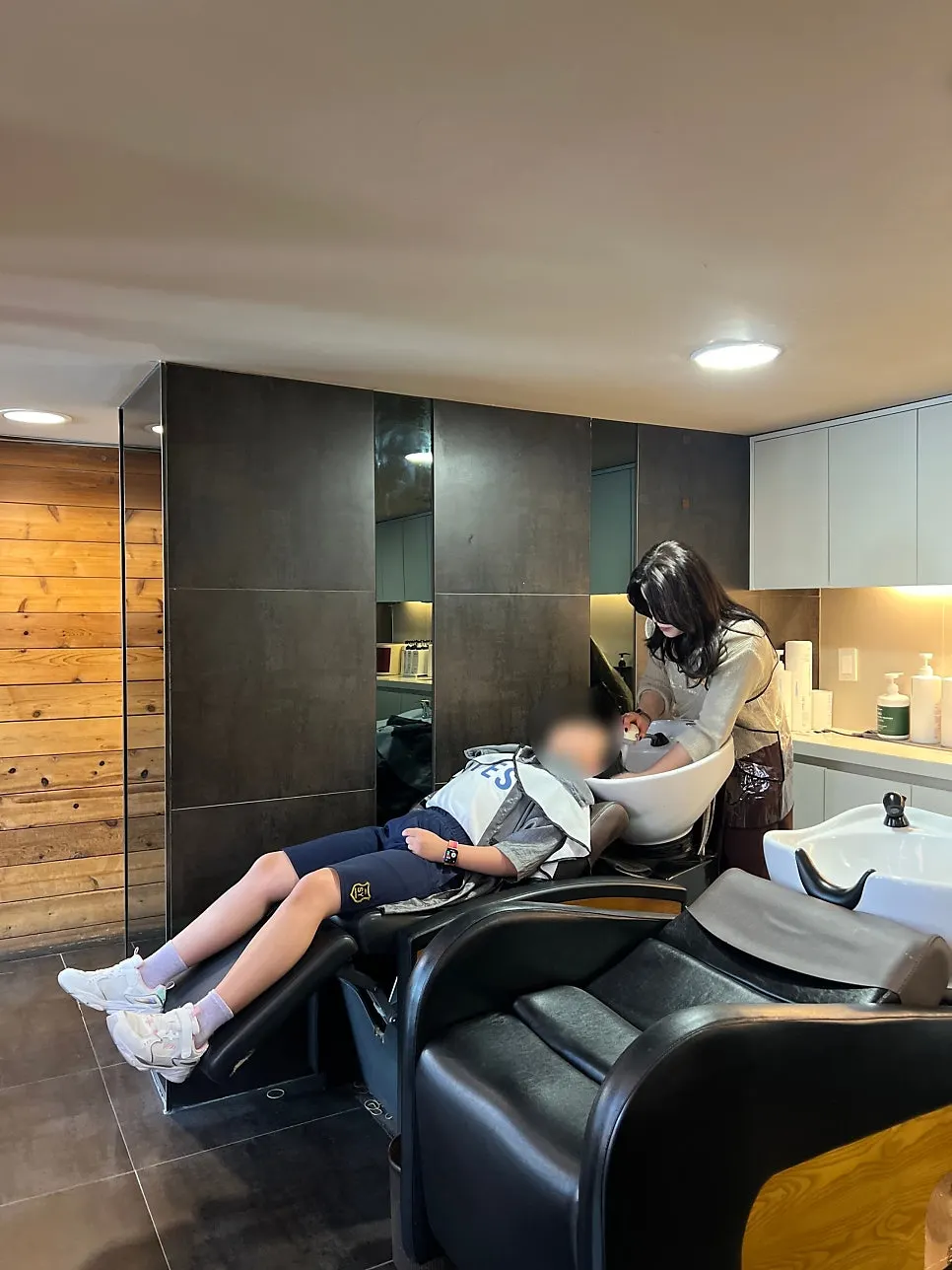 Elementary schooler getting her hair shampooed
