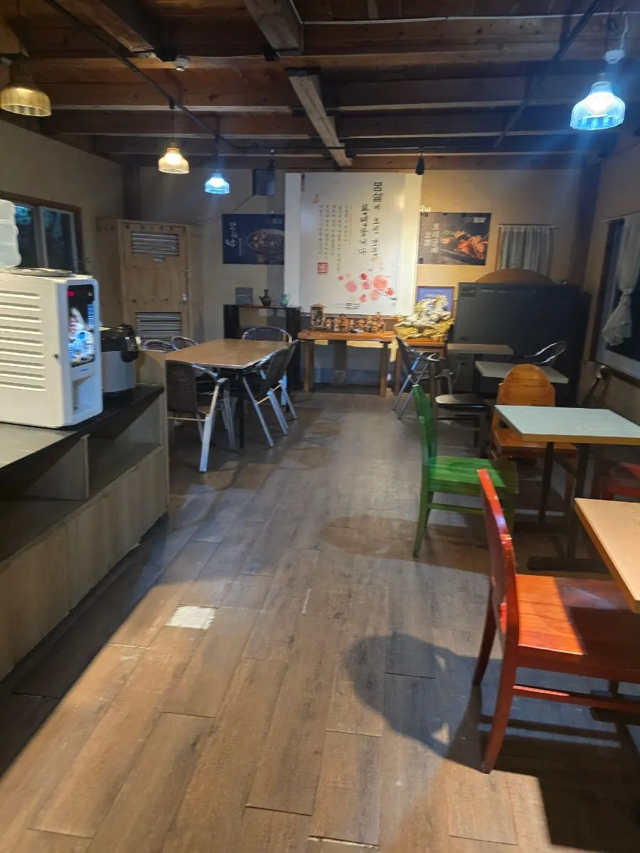 Bomseol's dining hall decorated with wooden tables and chairs
