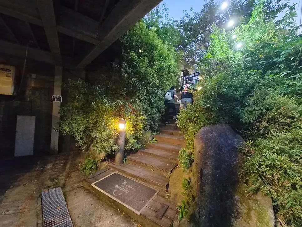 Stairs leading up to the restaurant next to the parking lot