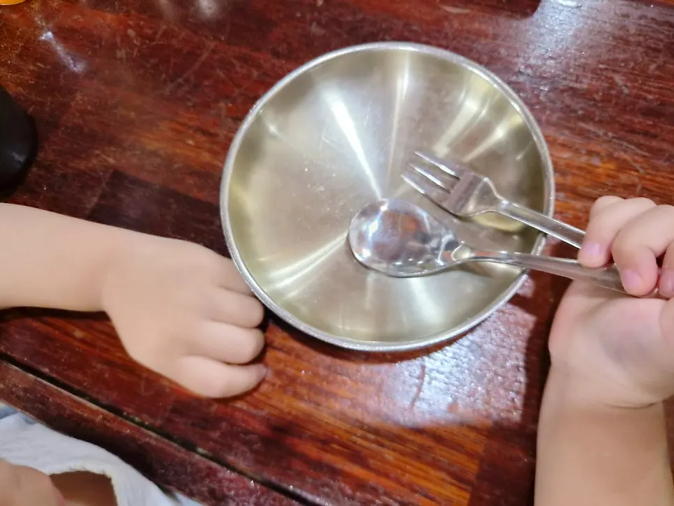 Table setting with a baby spoon prepared