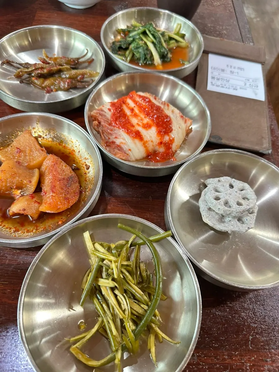 Mushroom and eggplant sweet-and-sour dishes with kimchi on the table