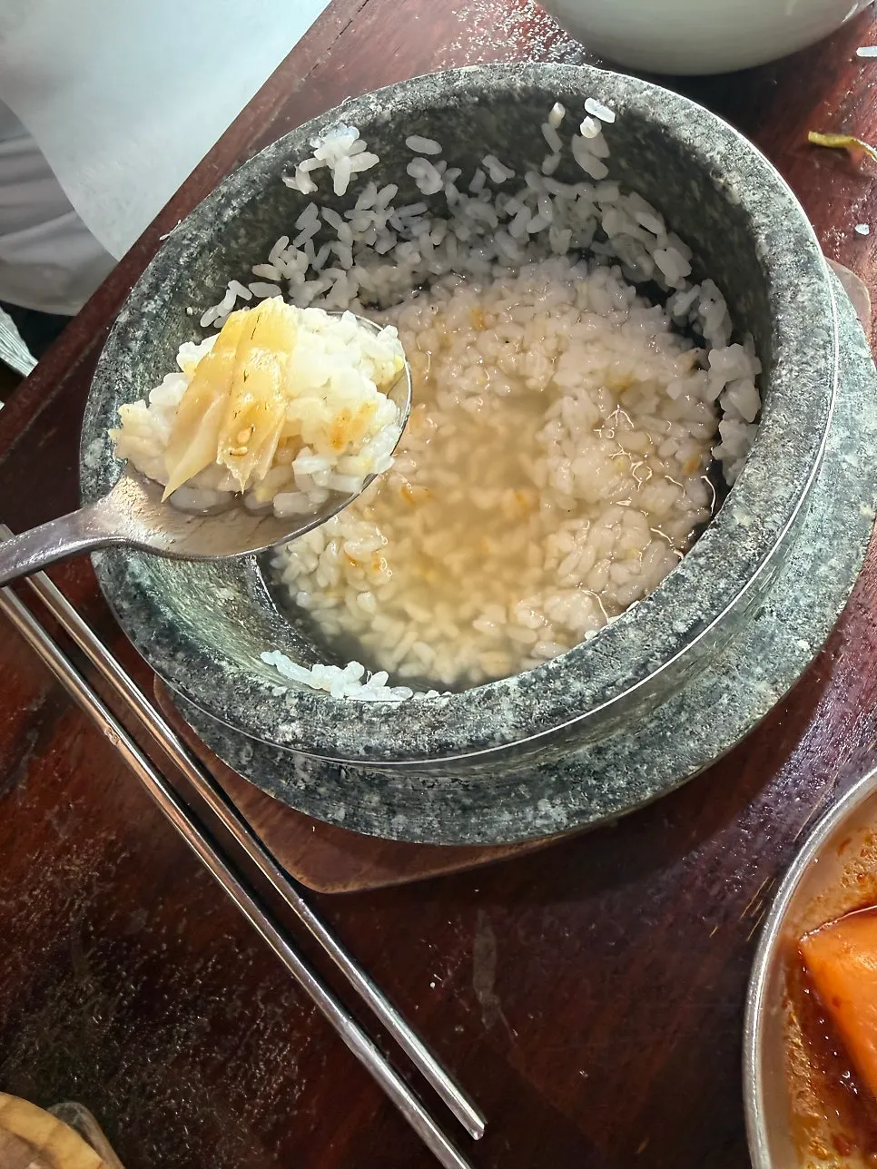 A piece of dried corvina placed on stone-pot rice