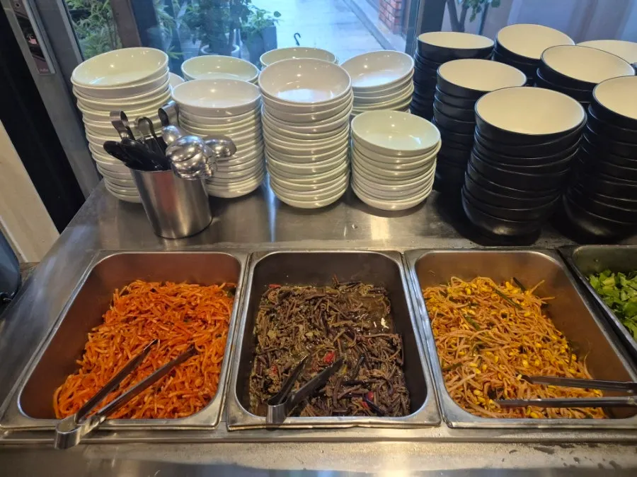 Vegetables and seasonings laid out at the self-serve corner