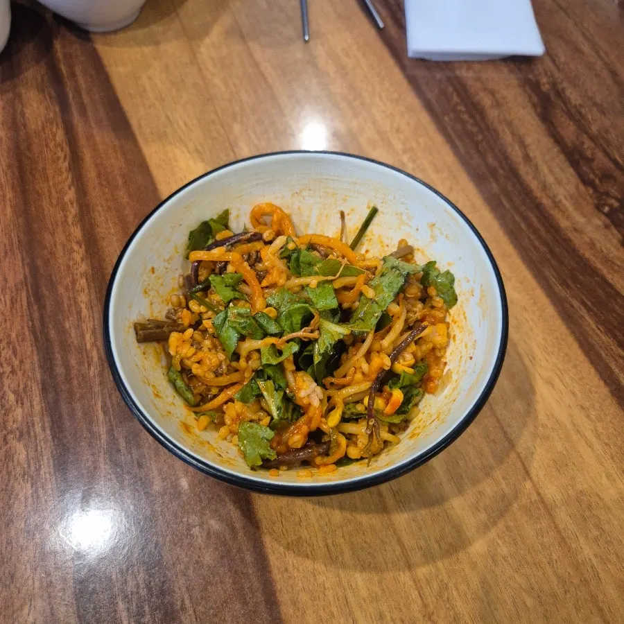Barley bibimbap mixed with gochujang and sesame oil