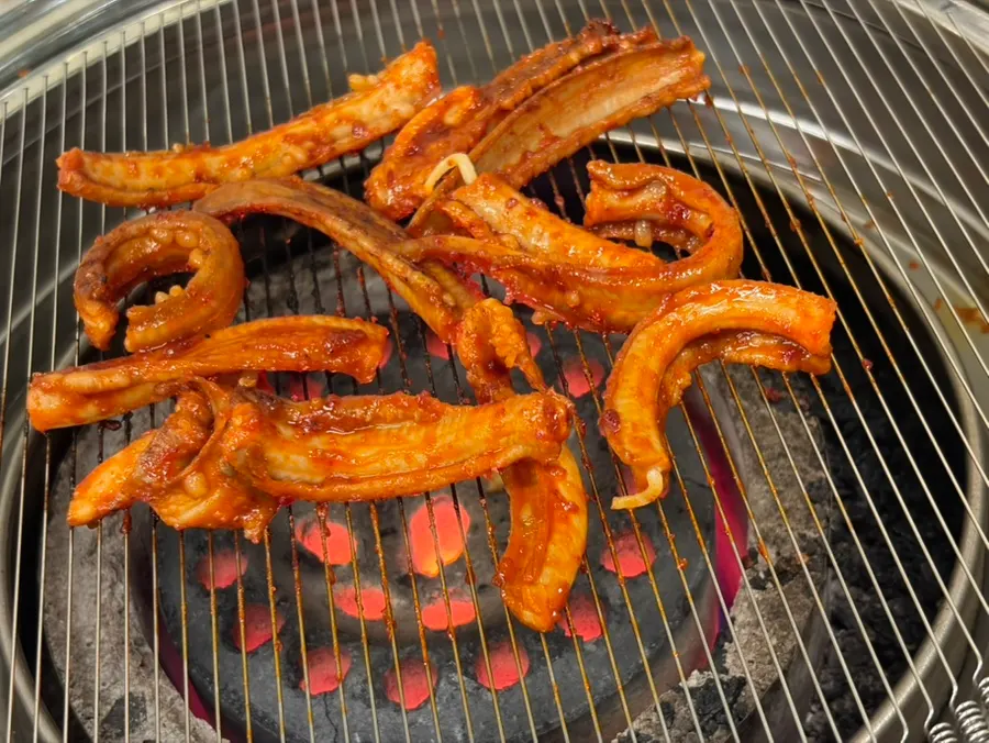 Marinated hagfish being grilled