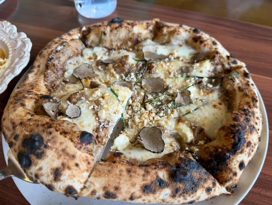 Miso Porcini wood-fired pizza on the table