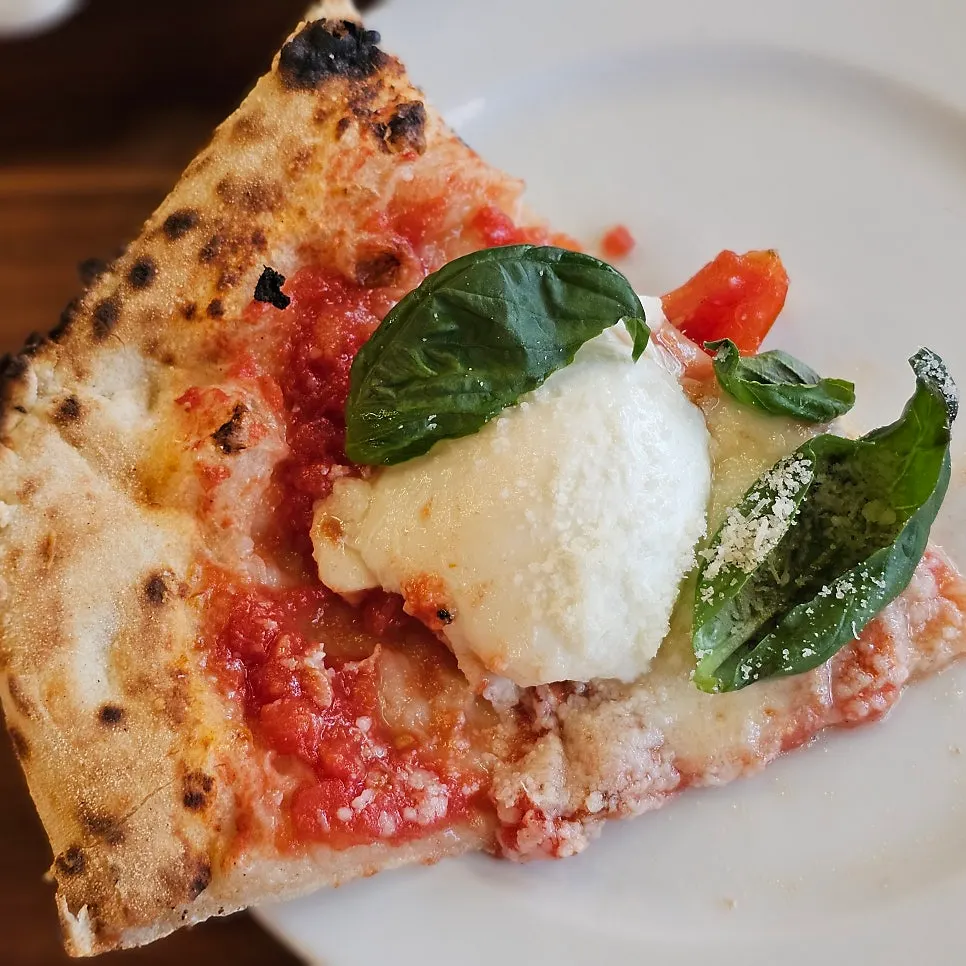 Close-up of the Margherita pizza topped with cheese and basil