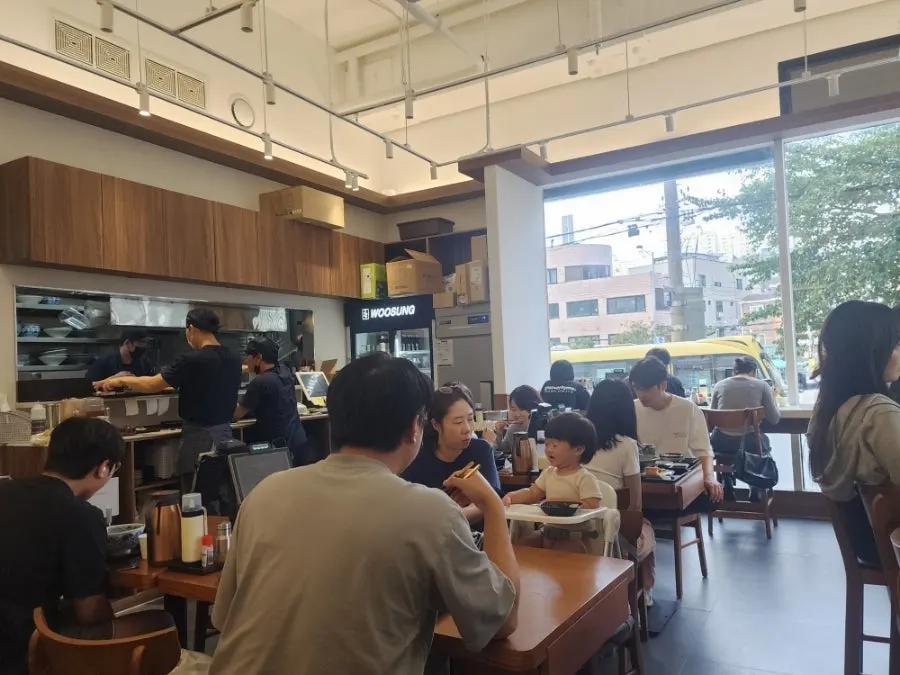 Wood-toned restaurant interior with lunchtime guests