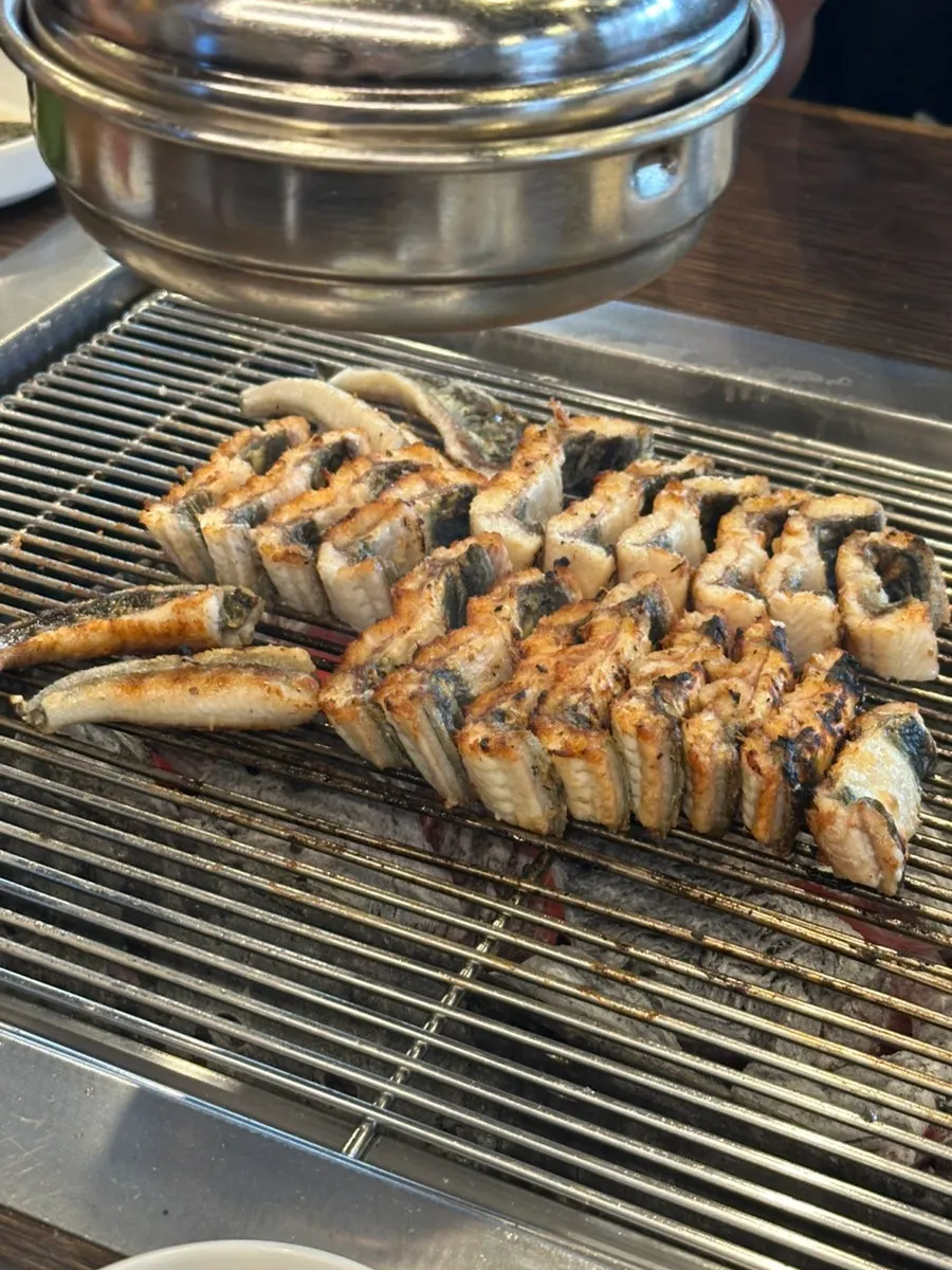 A bite of eel with seasoned chives