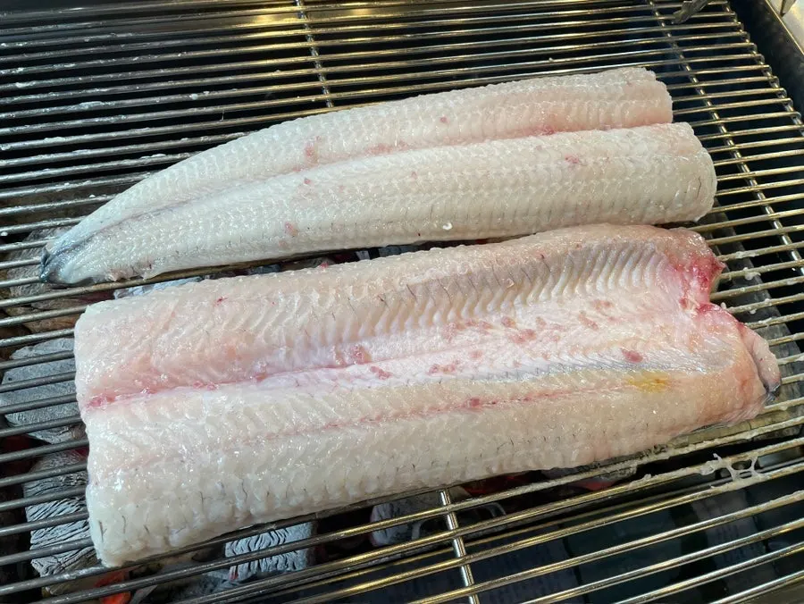 Large freshwater eel filling up the charcoal grill