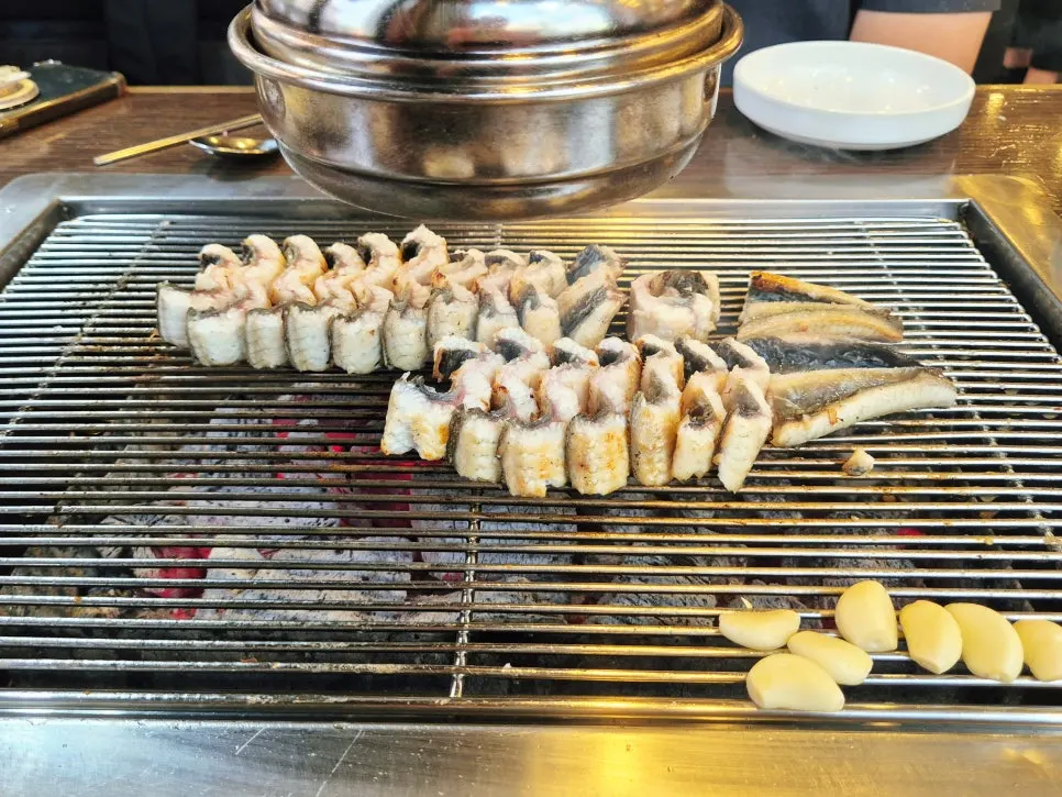 Staff member grilling the eel