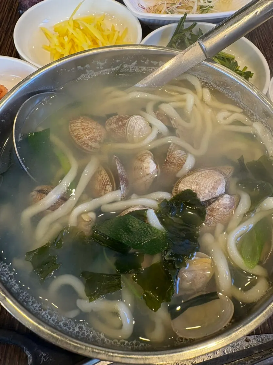 A glass of bokbunja next to grilled eel