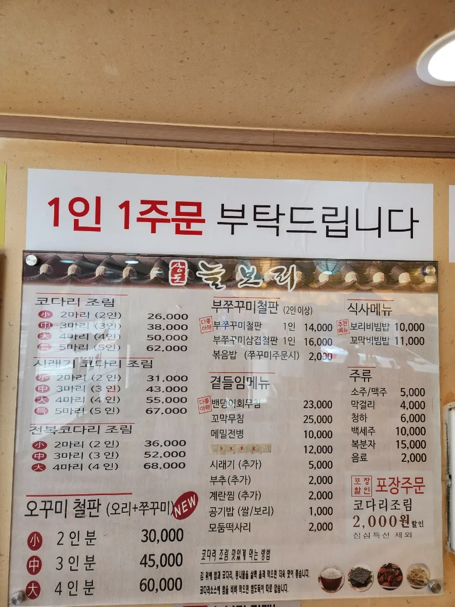 Menu board listing braised pollock and side dishes