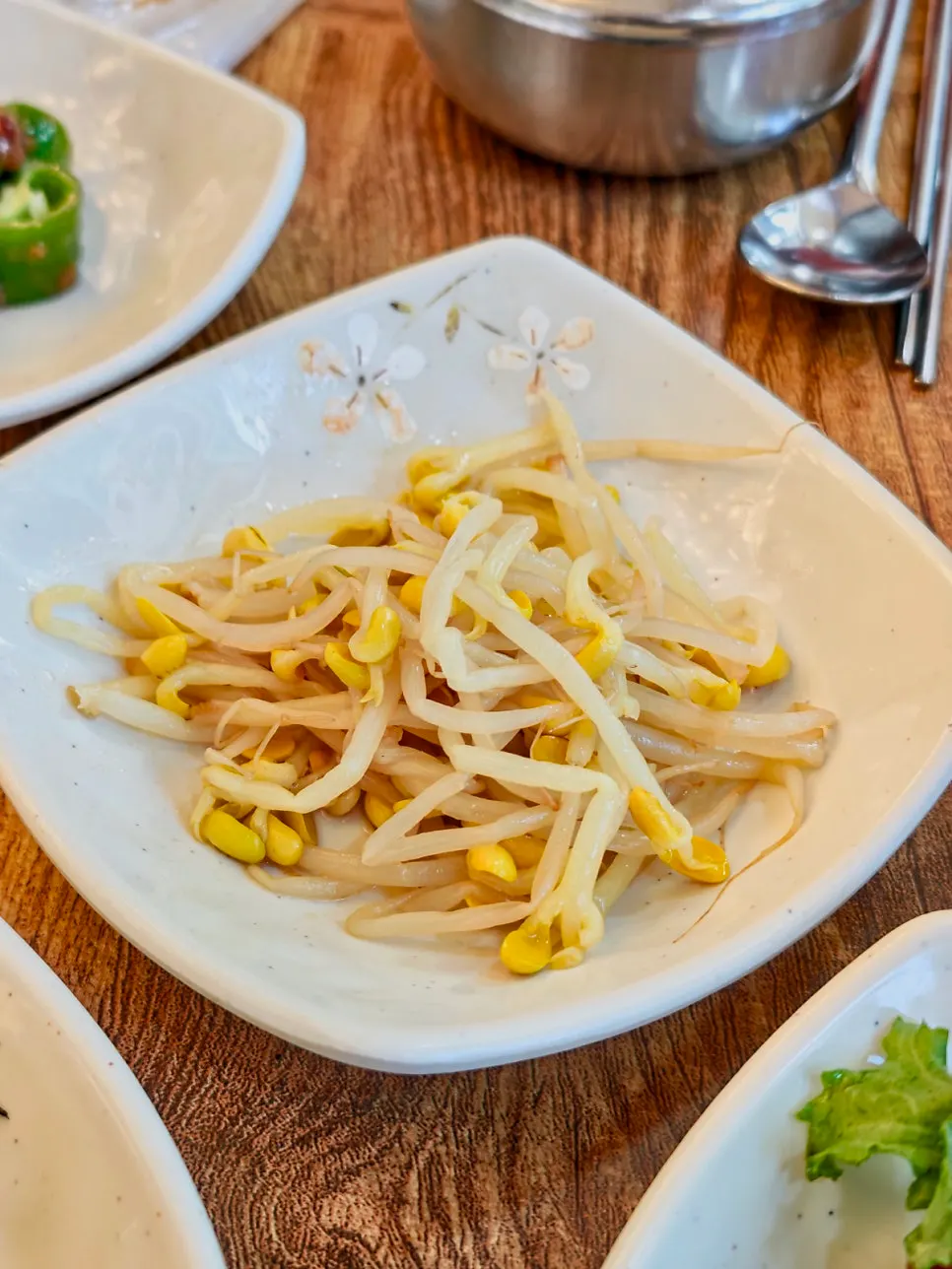 Korean side dishes including kkosiraegi salad and bean sprouts