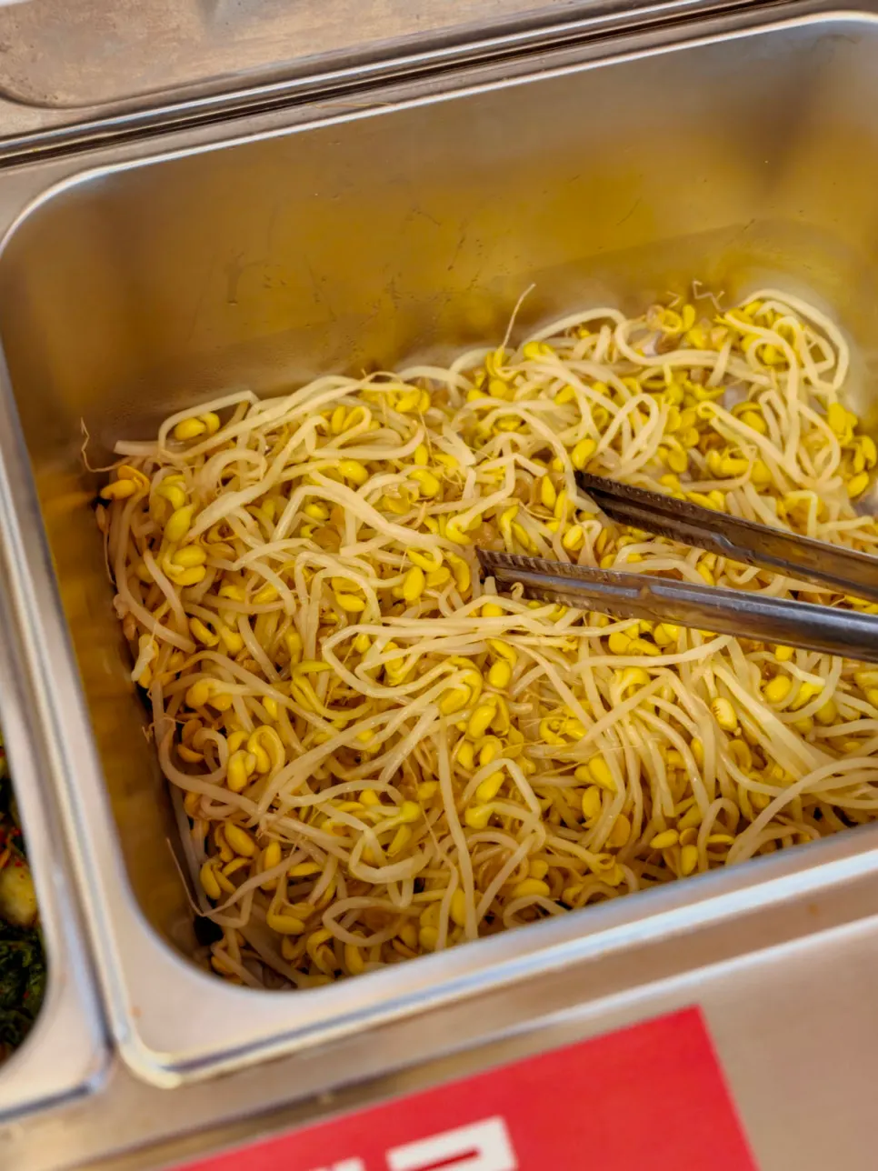 Barley rice and bibimbap ingredients in a metal bowl
