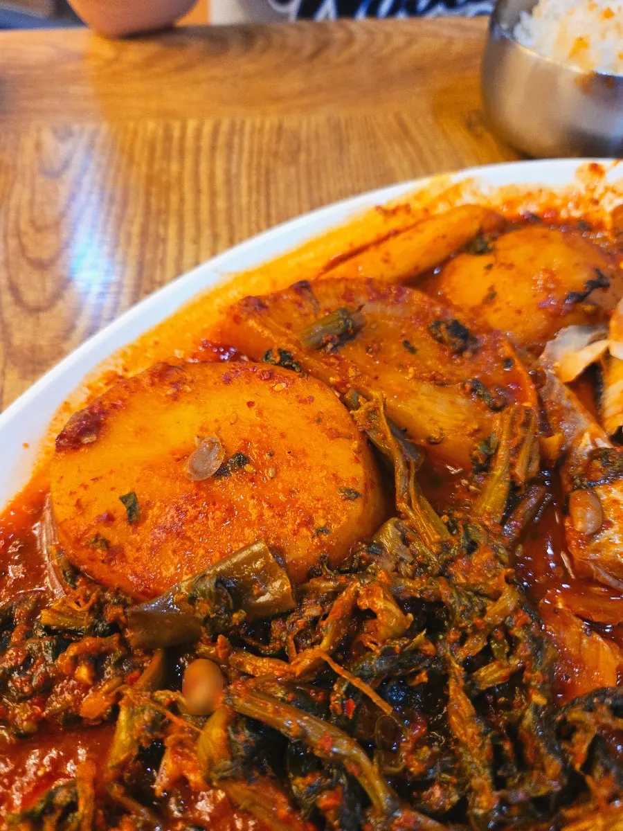 Pot with leftover sauce-soaked radish and potato