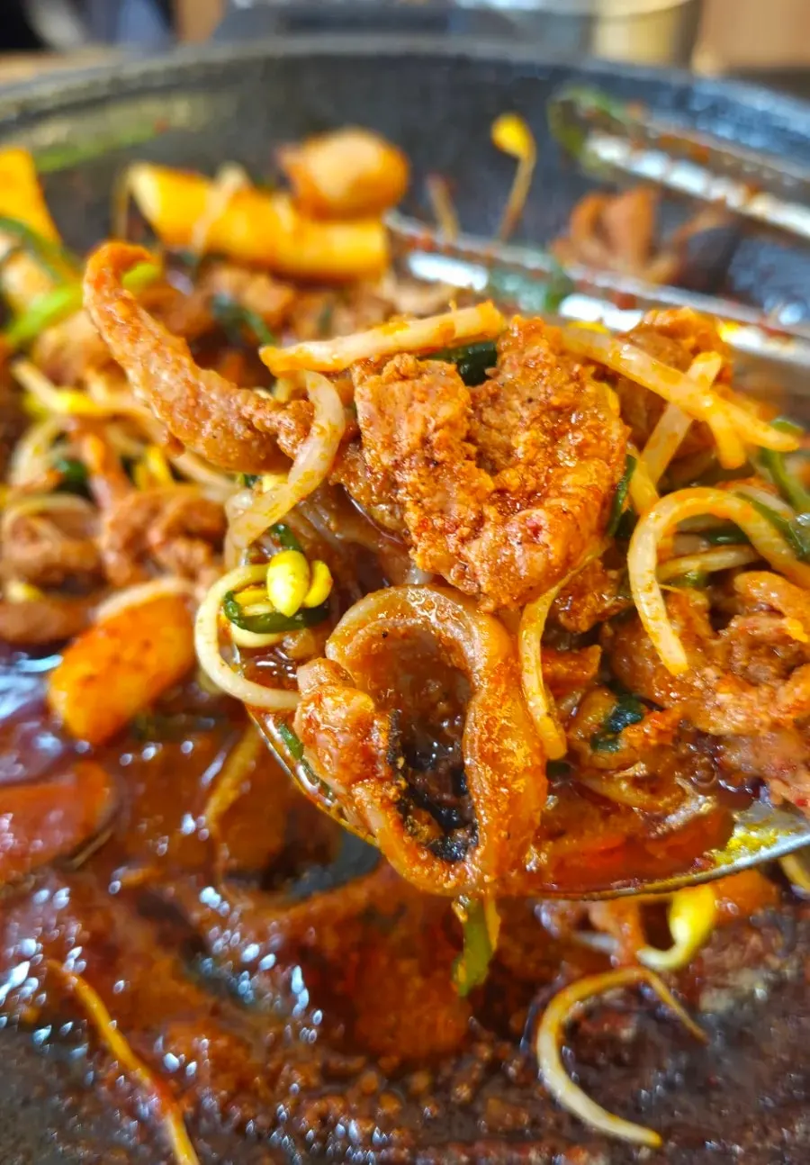 A mixed spoonful of cockle bibimbap