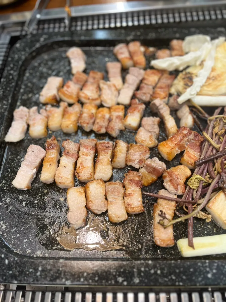 Korean pork belly grilling to a golden brown