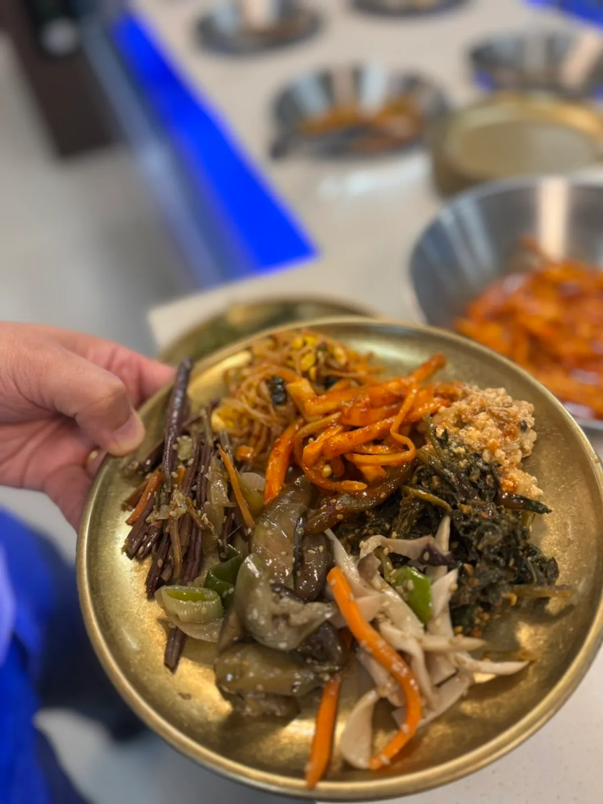 Warm self-serve bar corner with japchae and jeon