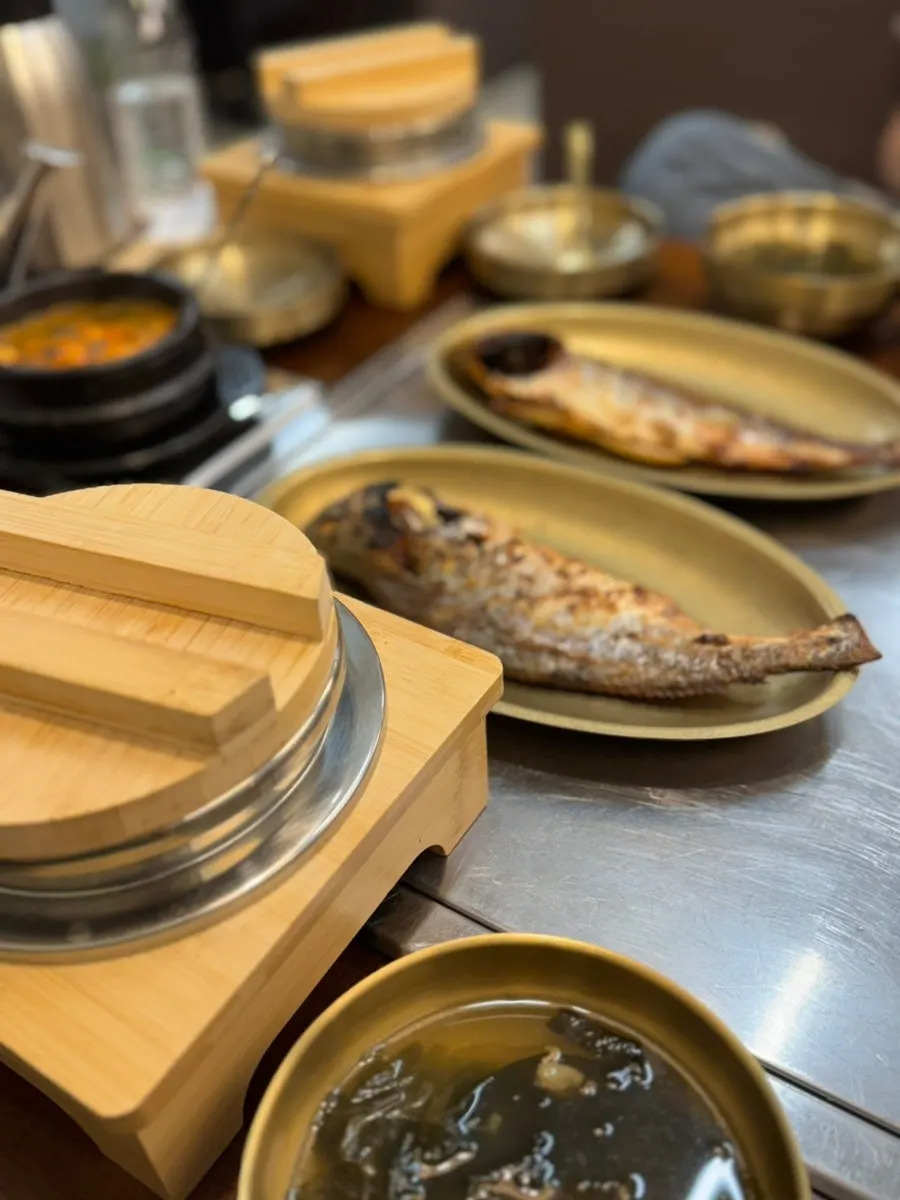 Basic side dishes and soup served in brass bowls