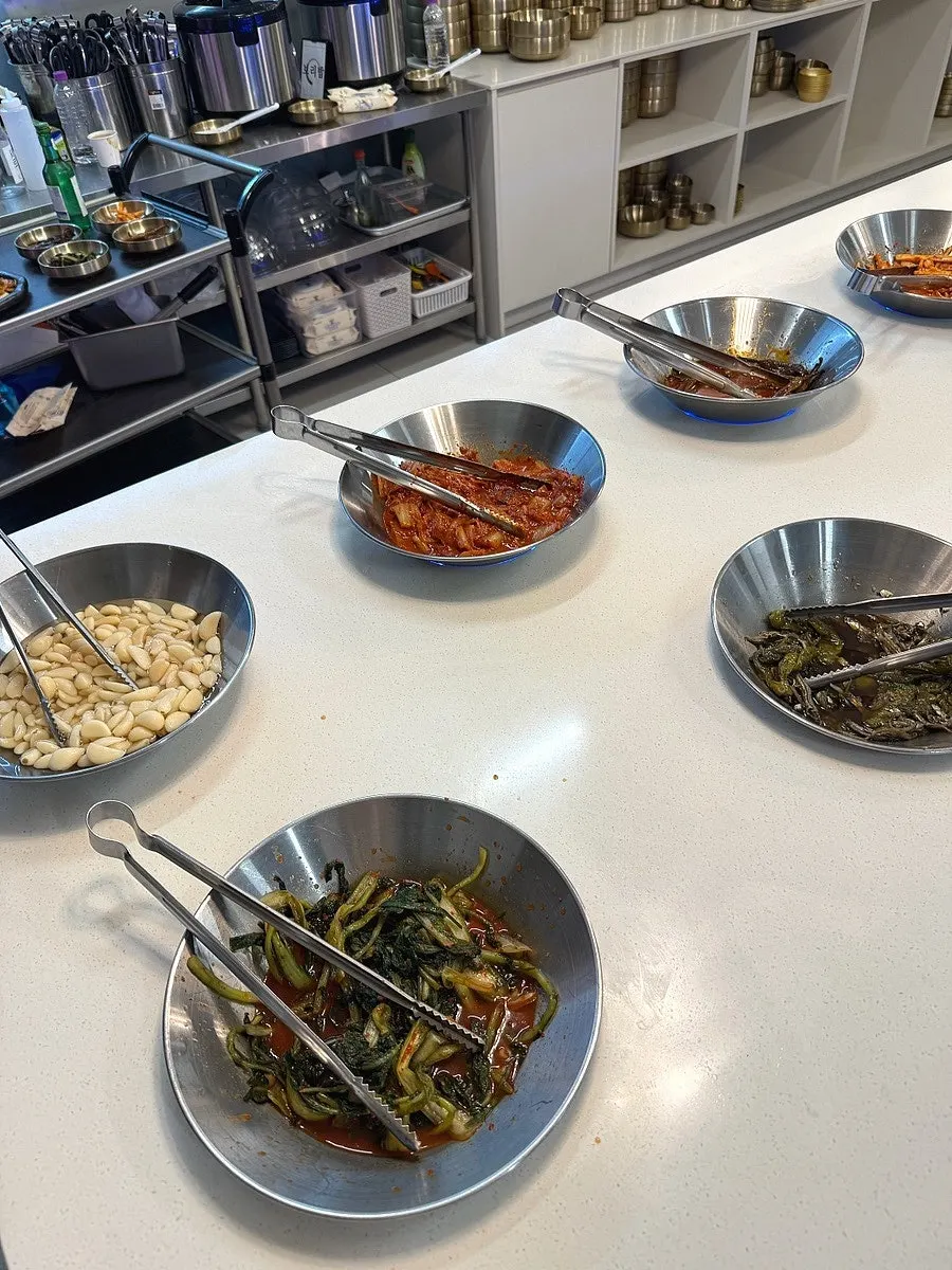 Self-serve bar with side dishes and vegetables at Hwadamga