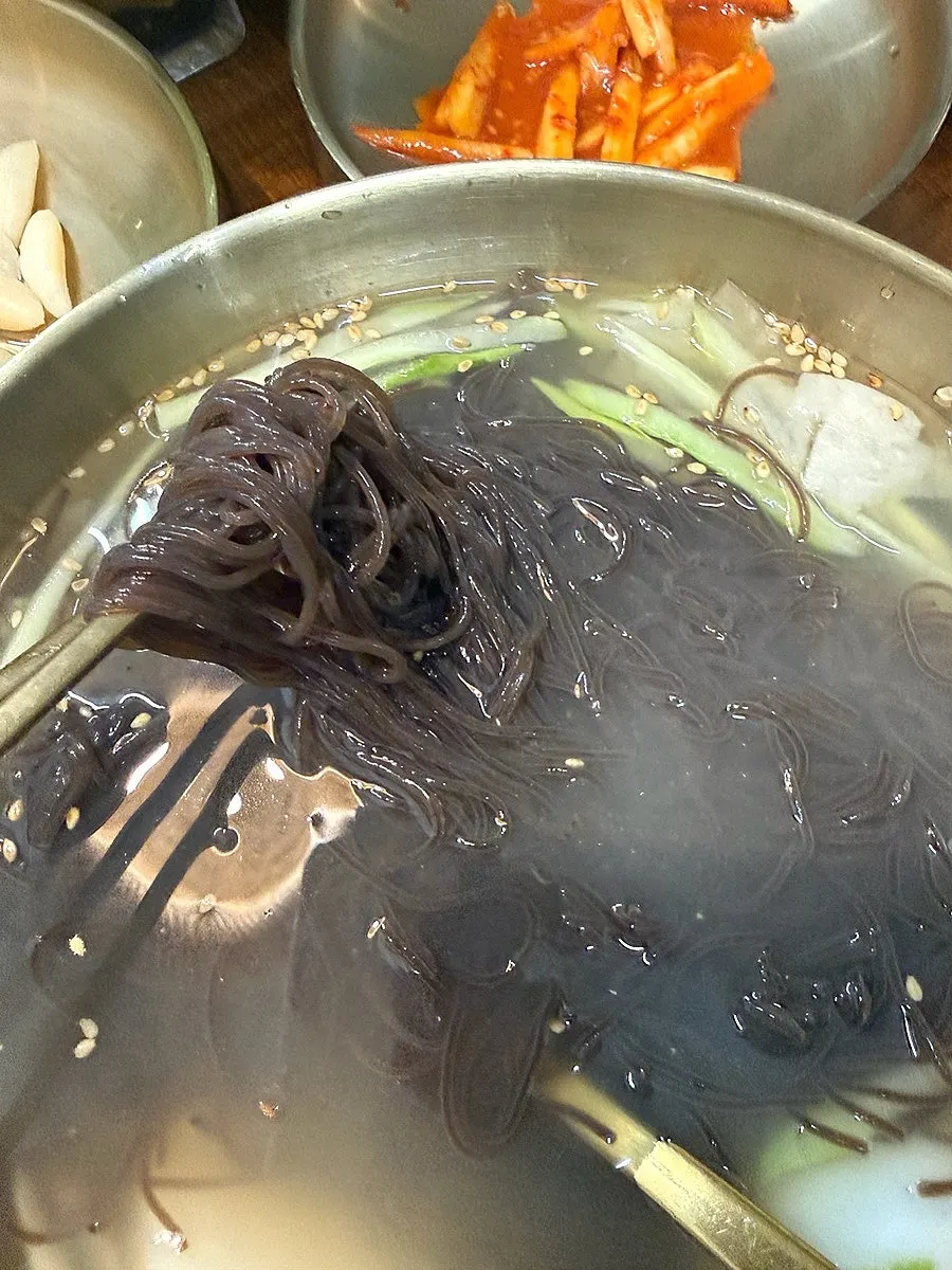 Hwadamga's mul-naengmyeon topped with generous pear slices