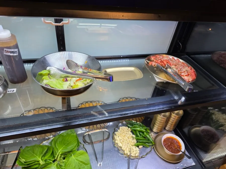 Salted seafood and doraji side dishes at the self-serve bar