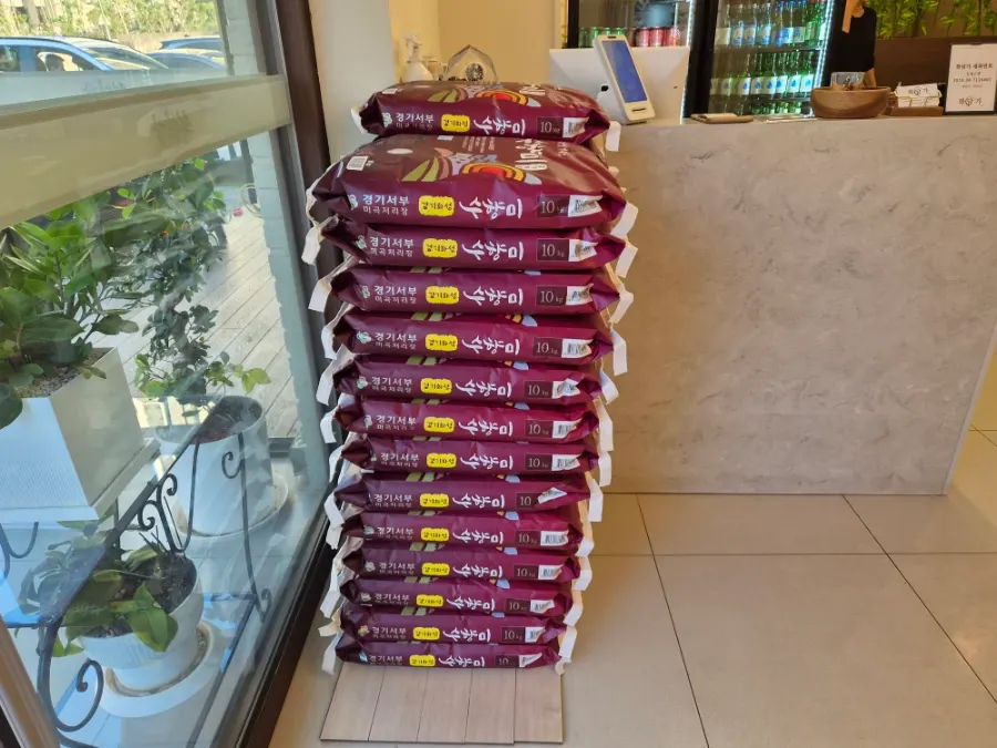 Sacks of Hwaseong Suhyangmi rice stacked at the entrance