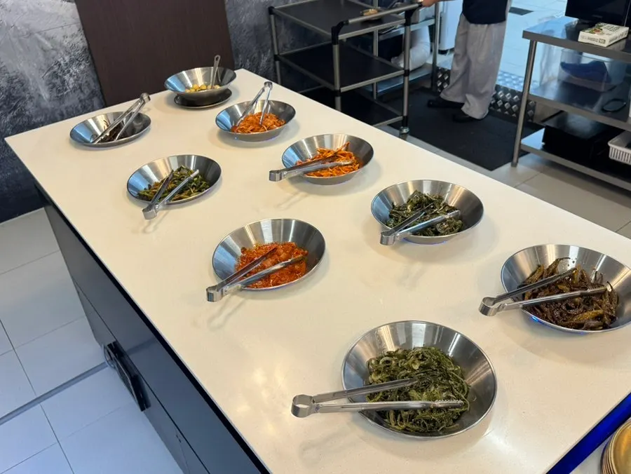 Containers of assorted namul at the self-serve bar